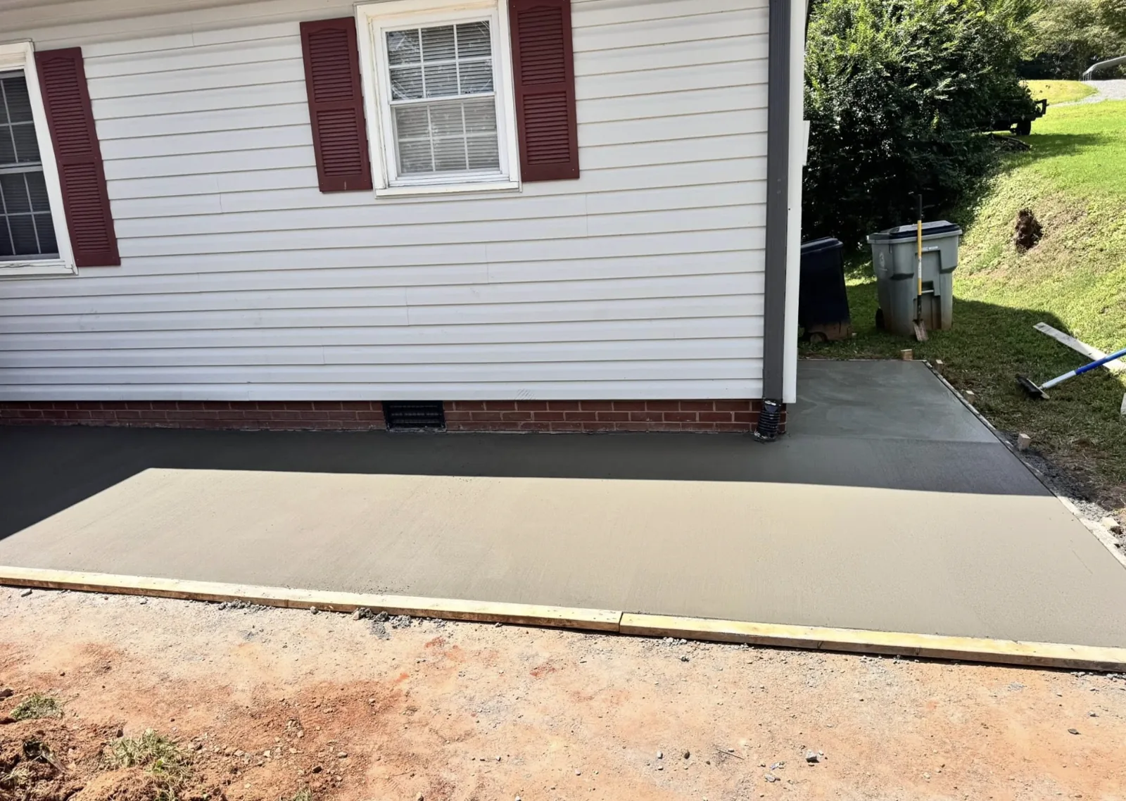 Finished concrete pad poured beside a residential home in the Hickory area